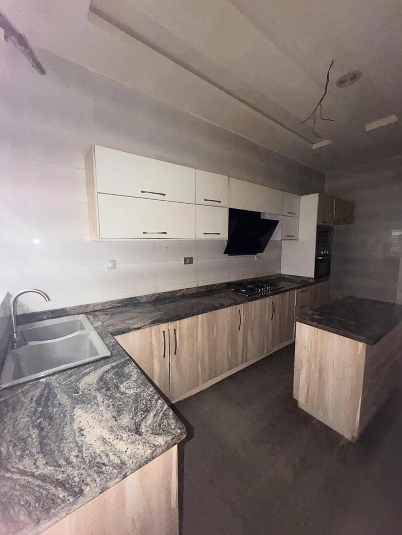 Fitted kitchen with island inside the Chevron Lekki rental duplex