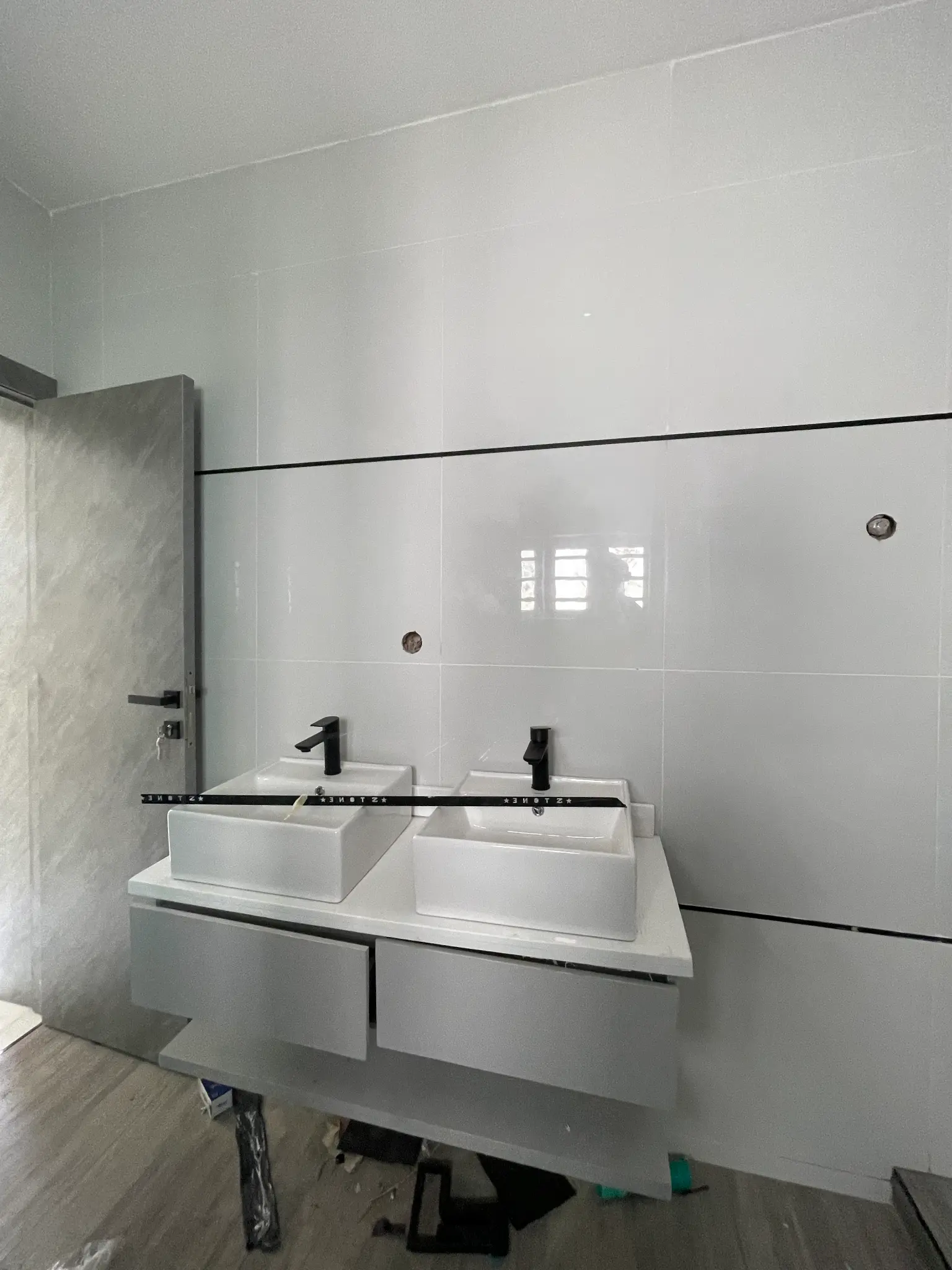 Double vanity bathroom detail inside the Ajah duplex