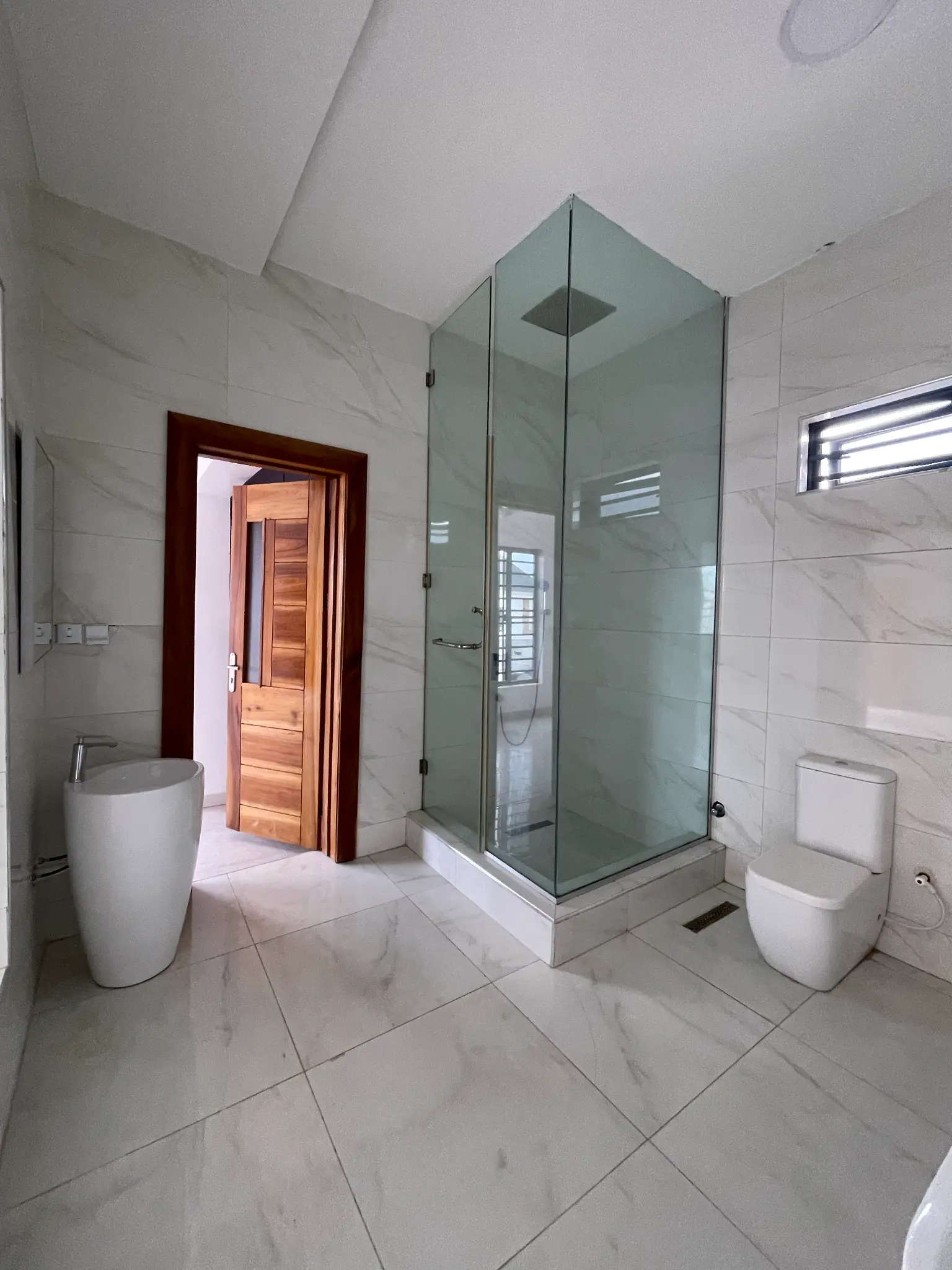 Glass shower bathroom inside the Ikota duplex